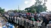 FILE - Police form a cordon outside a church where a Mass is celebrated for the freedom of political prisoners, in Masaya, Nicaragua, Aug. 28, 2019. 