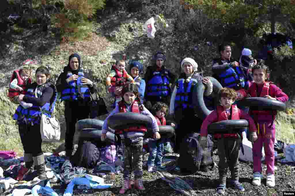Syrian migrants wear life-jackets and life-belts before boarding a dinghy to cross the Aegean Sea to the Greek island of Lesbos from the Ayvacik coast in Canakkale, Turkey.