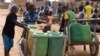 Displaced children that fled from their villages in northern Burkina Faso, following attacks by assailants, push carts loaded with water containers at a school on the outskirts of Ouagadougou, June 15, 2019.