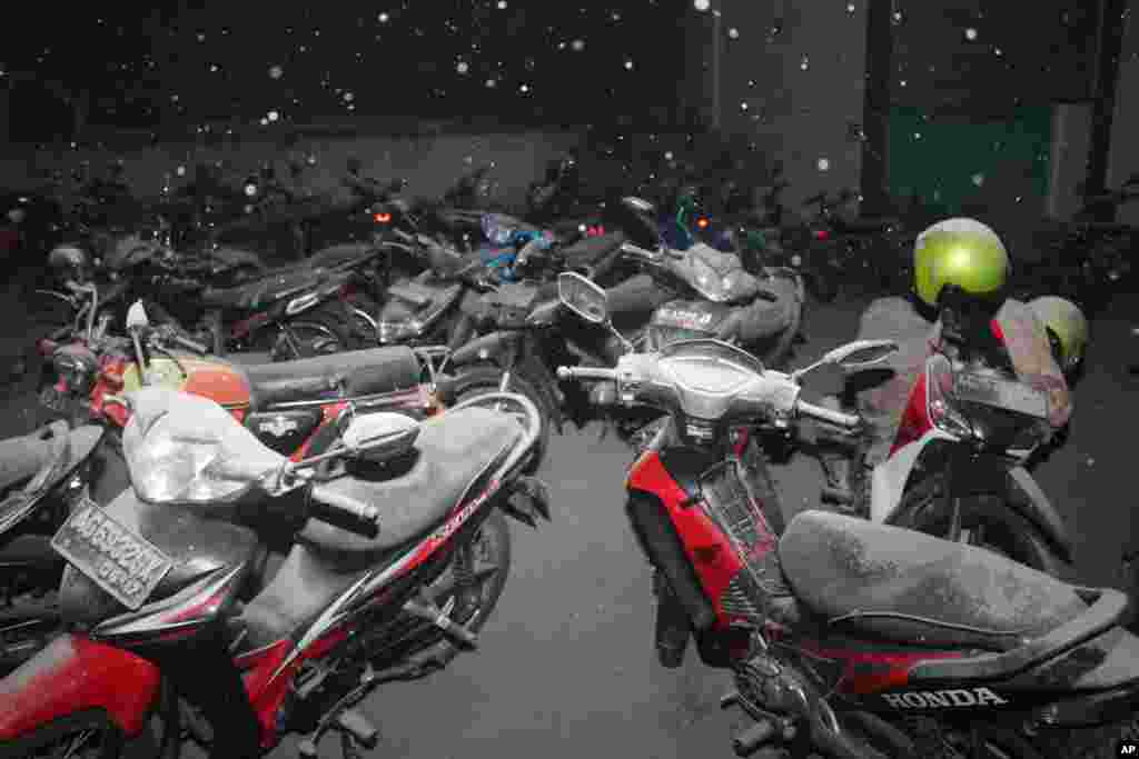 Volcanic ash from the eruption of Mount Kelud covers motor bikes in Kediri, East Java, Indonesia, Feb. 14, 2014.