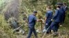 Police personnel surround the remains of an Air Dynasty chopper after it crashed in Nuwakot district, Nepal, on Aug. 7, 2024.