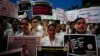 Doctors and medical students hold placards and candles during a protest against the rape and killing of a trainee doctor at a government hospital in Kolkata last week, in Ahmedabad, India, Aug. 17, 2024.
