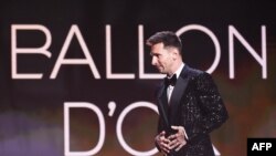 Paris Saint-Germain's Argentine forward Lionel Messi arrives to deliver a speech after being awarded the Ballon d'Or award during the 2021 Ballon d'Or France Football award ceremony at the Theatre du Chatelet in Paris on November 29, 2021.