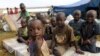 FILE - Burundian refugee children pose for a photograph at the Lake Tanganyika stadium in Kigoma, Tanzania, May 19, 2015. 