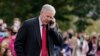 FILE - White House chief of staff Mark Meadows speaks on a phone on the South Lawn of the White House, Oct. 30, 2020.