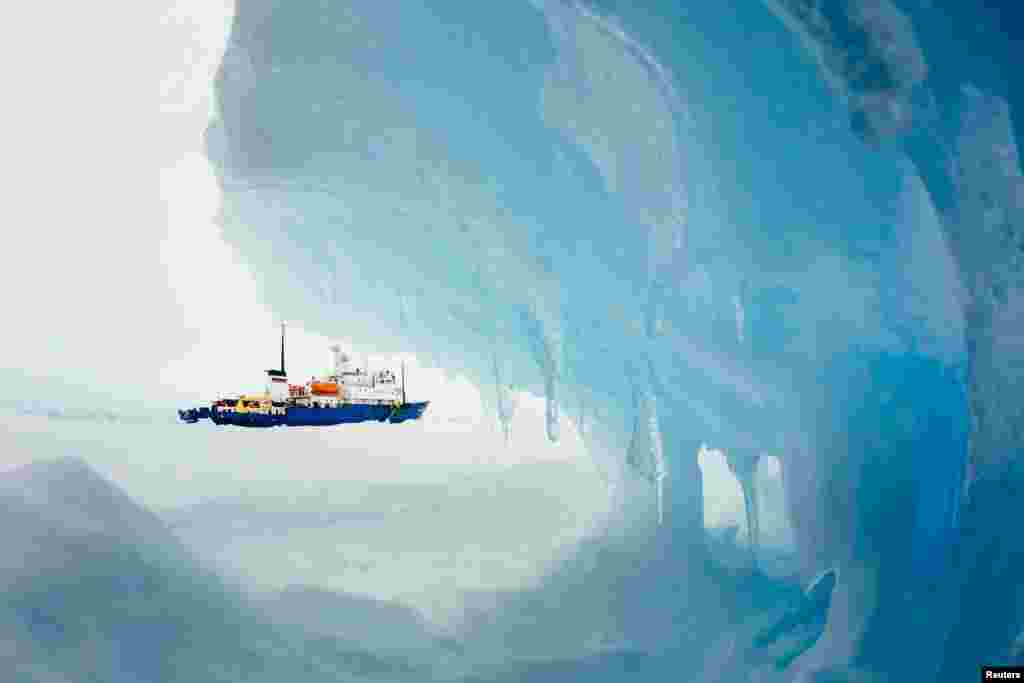 The MV Akademik Shokalskiy is seen stranded in ice in Antarctica, Dec. 29, 2013. An Antarctic blizzard has halted an Australian icebreaker's bid to reach a Russian ship trapped for a week with 74 people onboard, rescuers said.