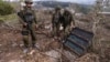 In a photo edited under Israeli military supervision, Israeli soldiers show what they say is a Hezbollah attack tunnel on Oct. 13, 2024.