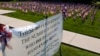FILE - Some of the 660 American flags on display, illustrating the number of U.S. veterans who commit suicide each year, are seen by the banner on the church lawn of St. Peter's Reformed Church, in Zelienople, Pa., Aug. 30, 2019.