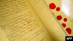 FILE - The original document of the 1st Geneva Convention "for the Amelioration of the Condition of the Wounded in Armies in the Field" signed in 1864 is seen at the International Red Cross and Red Crescent Museum in Geneva, Switzerland.