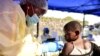 FILE - A Congolese health worker administers Ebola vaccine to a child at the Himbi Health Centre in Goma, Democratic Republic of Congo, July 17, 2019. 
