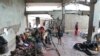 Survivors of Cyclone Idai wait in an abandoned and derelict building near Nhamatanda, about 50 kilometers from Beira, in Mozambique, March, 22, 2019. 
