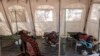 FILE - Patients suffering from cholera receive treatment inside a tent converted into a temporary field hospital near the remote village of Dor, Sudan, April 28, 2017.