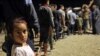 FILE - Syrians who fled their homes because of the Turkish military operation in northeastern Syria are pictured upon arriving at the Bardarash camp, near the Kurdish city of Dohuk, in Iraq's autonomous Kurdish region, Oct. 20, 2019.