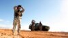 FILE - In this Jan. 19, 2007, photo, a National Guard unit patrols at the U.S.-Mexico border in Sasabe, Arizona.