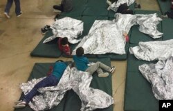 부모와 함께 미국과 멕시코 국경을 통해 미국으로 밀입국하다 적발된 어린이들이 17일 텍사스주 매캘런의 한 수용시설에서 부모와 격리된 채 콘크리트 바닥에 매트리스를 깔고 누워 있다.