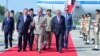 This handout photograph taken and released by Pakistan's Prime Minister Office on October 14, 2024 shows China's Premier Li Qiang, center left, speaking with Pakistan's Prime Minister Shehbaz Sharif upon his arrival at the Chaklala military air base inIslamabad.