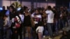 FILE - Venezuelans wait to pass immigration control at the Ecuador-Peru border, before the deadline on stricter regulations that require passports, in Tumbes, Peru, June 14, 2019. 