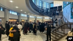 People arrive at Parliament in Wellington, New Zealand, on July 24, 2024, for the final report of a wide-ranging independent inquiry into the abuse of children and vulnerable adults over the span of five decades.