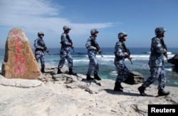 Soldiers of China's People's Liberation Army (PLA) Navy patrol at Woody Island, in the Paracel Archipelago, which is known in China as the Xisha Islands, Jan. 29, 2016.