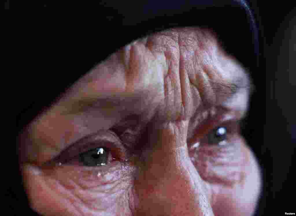 Fayza Hider, whose son was in Sednaya prison since 2013, which was known as a slaughterhouse under Syria's Bashar al-Assad's rule, reacts while she searches for her son there, in Sednaya, Dec. 16, 2024.