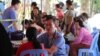 FILE PHOTO - Tan Song, a doctor, and president of the Cambodian Health Professionals Association of America (CHPAA) examines a patient during a medical mission in Cambodia's Svay Rieng province, Cambodia. 
