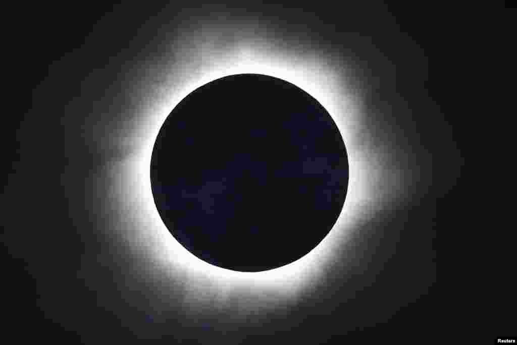 A total solar eclipse is seen from the beach of Ternate island, Indonesia.