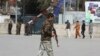 An Afghan security police walks in the site of explosion in Kabul, Afghanistan, March 21, 2019. 