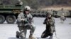 FILE - A U.S. Army soldier and a South Korean Army soldier take their position during joint military exercises between South Korea and the United States in Pocheon, north of Seoul, South Korea, March 25, 2015.