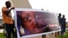 FILE - People carry a banner during a remembrance ceremony for the children who were killed during an attack on the Dogon village of Sobane Da, at the Monument de la Paix in Bamako, Mali, June 15, 2019.