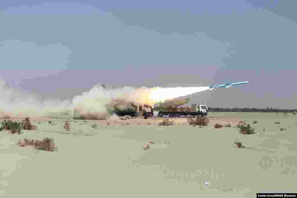 Iran&#39;s military launches a missile during a navy exercise in the Gulf of Oman.