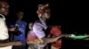 FILE - South Sudanese refugees receive food after being transported from the border of South Sudan and the Democratic Republic of the Congo to a refugee settlement site in Aru, DRC, May 10, 2019. 