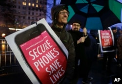 FILE - Protesters demonstrate outside the Apple store on Fifth Avenue in New York, Feb. 23, 2016.