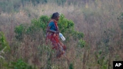 An Indian woman walks in a field after relieving herself in the open, on World Toilet Day on the outskirts of Jammu, India, Nov. 19, 2014. Some villages have public bathrooms, but many women avoid using them because they are usually in disrepair and men hang around and harass women.