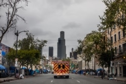 An ambulance of the LAFD Station No9 rides at Skid Row on April 12, 2020 in downtown Los Angeles, California.