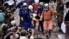 A rescue team carries out a wounded worker from a collapsed building in Sihanoukville, Cambodia June 24, 2019. 