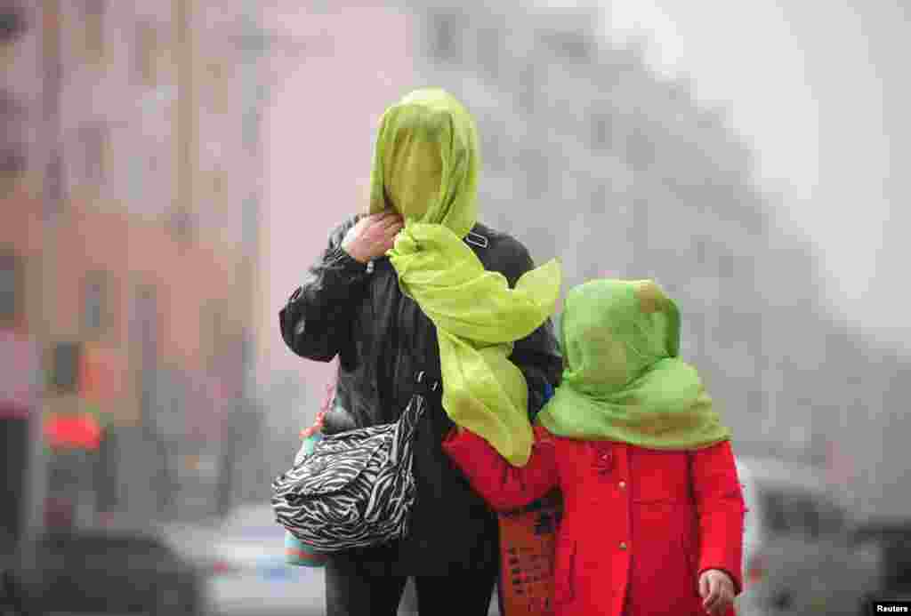 People walk during a polluted day in Shenyang, Liaoning province, China.