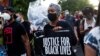 FILE - People participate in a demonstration on the first anniversary of the death of George Floyd, in Brooklyn, New York, May 25, 2021.
