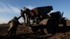 Service members with the Ukrainian Army's 10th Mountain Assault Brigade unit prepare a BM-21 Grad self- propelled multiple rocket launcher, as Russia's attack on Ukraine continues, for launching near the frontlines in the Bakhmut region of Ukraine, Dec. 7, 2022. 