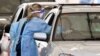 A member of the medical personnel takes a swab at a drive-through Covid-19 testing station in Melbourne, Aug. 19, 2021, as Australia battles an outbreak of the Delta variant of coronavirus. 