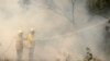 Rural Fire Service firefighters control a backburn in an effort to contain an approaching fire near Nattai, southwest of Sydney, Australia, Dec. 7, 2019. 