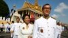 In this file photo taken on Oct. 29, 2014, Sam Rainsy, acting president of the outlawed Cambodia National Rescue Party (foreground) walks together with his wife Tioulong Saumura, after attending a celebration marking 10th anniversary of King Sihamoni, in Phnom Penh. 