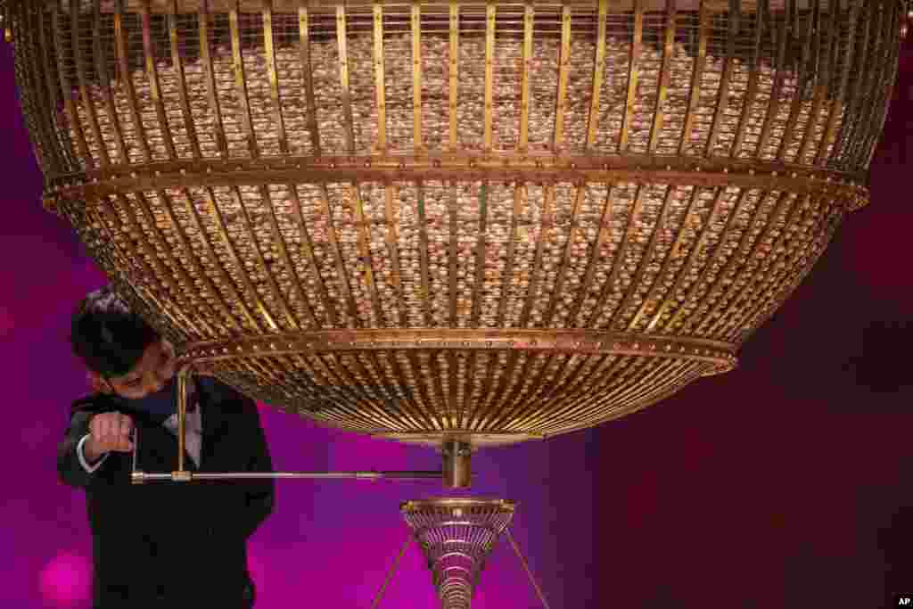 A ball bearing a ticket number falls from a giant drum at Madrid&#39;s Teatro Real opera house during Spain&#39;s bumper Christmas lottery draw known as El Gordo, or The Fat One, in Madrid.