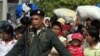 Thai police escort a group of Myanmar refugees crossing to Myawaddi town at the Thai-Myanmar border town of Mae Sot (File Photo)