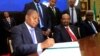 FILE - Central African Republic President Faustin Archange Touadera signs a peace deal between the Central African Republic government and 14 armed groups following two weeks of talks in the Sudanese capital Khartoum, Sudan, Feb, 5, 2019. 