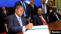 FILE - Central African Republic President Faustin Archange Touadera signs a peace deal between the Central African Republic government and 14 armed groups following two weeks of talks in the Sudanese capital Khartoum, Sudan, Feb, 5, 2019. 