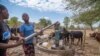 FILE - Villagers pump water at a borehole in Mudzi, Zimbabwe, July 2, 2024. Five countries — Lesotho, Malawi, Namibia, Zambia and Zimbabwe — have declared national disasters over the drought and resultant hunger. 