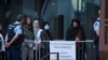 Family members of victims of the mosque attacks arrive for the start of gunman Brenton Tarrant's sentencing outside the High Court in Christchurch, New Zealand, August 24, 2020.