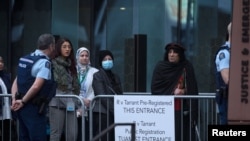 Family members of victims of the mosque attacks arrive for the start of gunman Brenton Tarrant's sentencing outside the High Court in Christchurch, New Zealand, August 24, 2020.