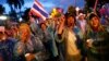 Anti-government protesters wear colorful rain coats as they block the road outside the Interior Ministry in Bangkok, Nov. 26, 2013.