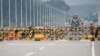 FILE - A soldier stands guard at a checkpoint on the Grand Unification Bridge which leads to the inter-Korean Kaesong Industrial Complex in North Korea, just south of the demilitarized zone separating the two Koreas, in Paju, South Korea, June 17, 2020. 